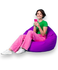 Young girl using a mobile phone sitting on a purple bean bag